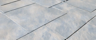 Barletta Bush Hammered Bluestone Pavers showcasing a textured, slip-resistant surface and rich blue-gray color, ideal for durable and stylish outdoor flooring.