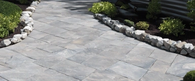 MillStone Pavers showcasing a rugged texture and earthy tones reminiscent of natural stone, perfect for adding timeless charm to outdoor landscapes and pathways.