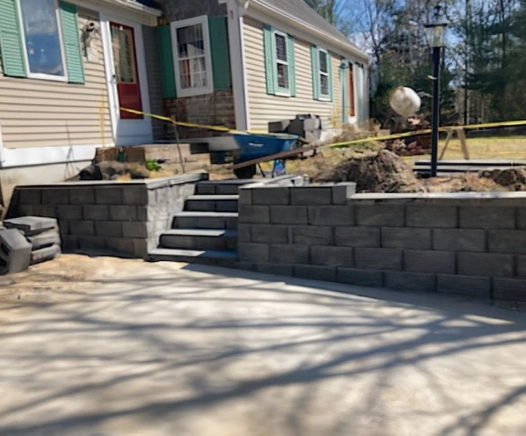 Stone retaining wall and steps from a house in Wellfleet, MA. Designed by Cape Cod Hardscapes